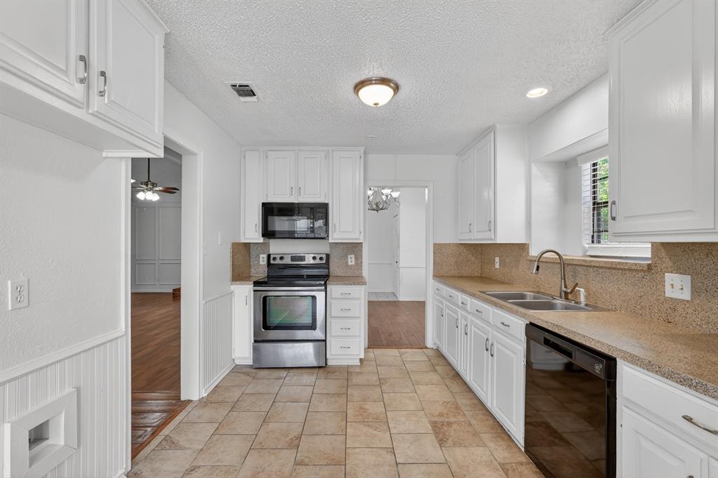 2403 Ridgevalley Drive McKinney, TX 75071 - Photo 8 of 21 a kitchen with stainless steel appliances granite countertop a sink stove and refrigerator
