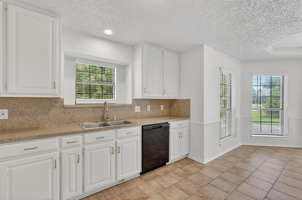 2403 Ridgevalley Drive McKinney, TX 75071 - Photo 9 of 21 a kitchen with a sink cabinets and window