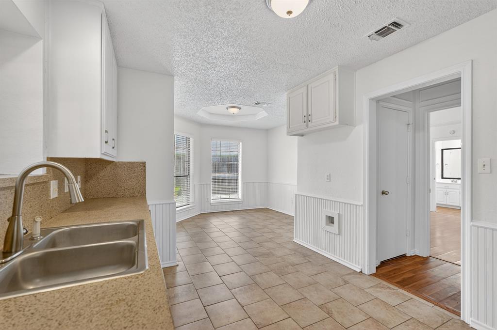 2403 Ridgevalley Drive McKinney, TX 75071 - Photo 10 of 21 a kitchen with granite countertop a refrigerator and a sink