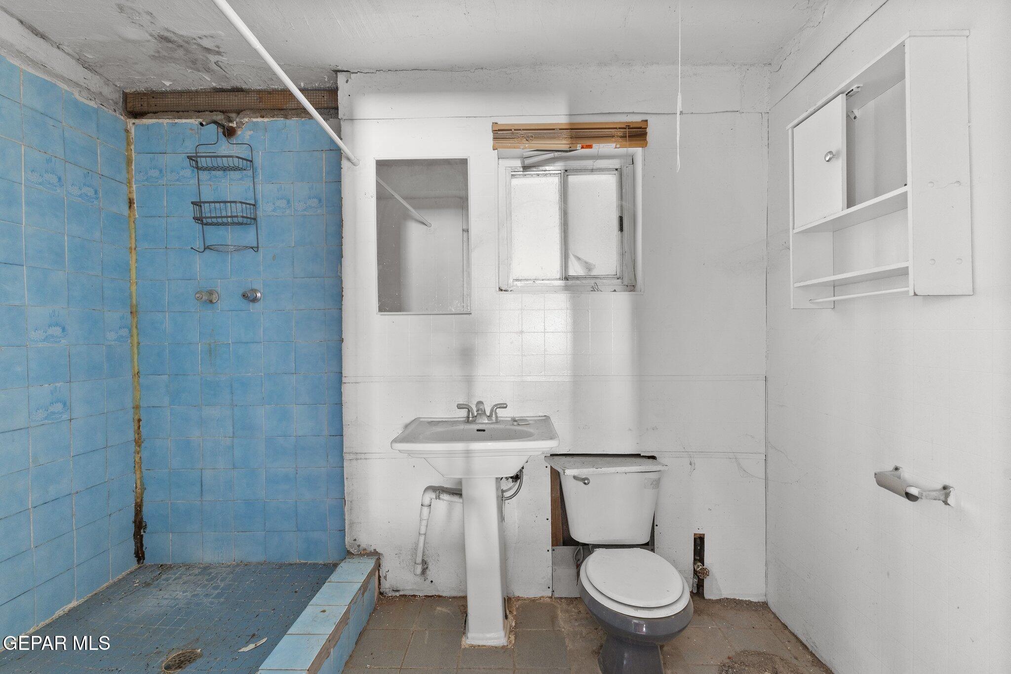 7080 2nd Avenue Canutillo, TX 79835 - Photo 17 of 38 a bathroom with a granite countertop sink a toilet and shower