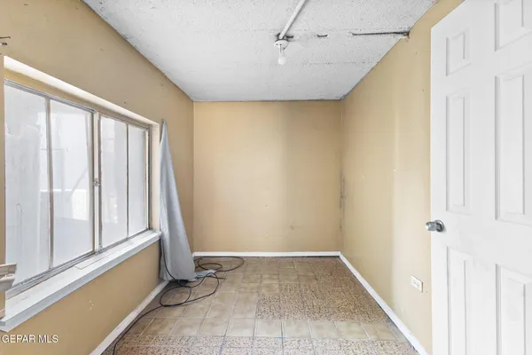 a view of staircase with white walls and white door