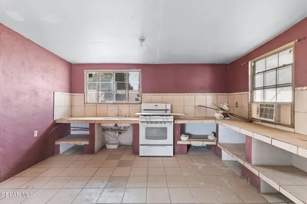 a kitchen with a stove a sink and a refrigerator