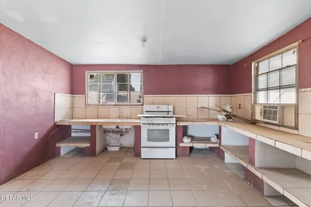 a kitchen with a stove a sink and a refrigerator