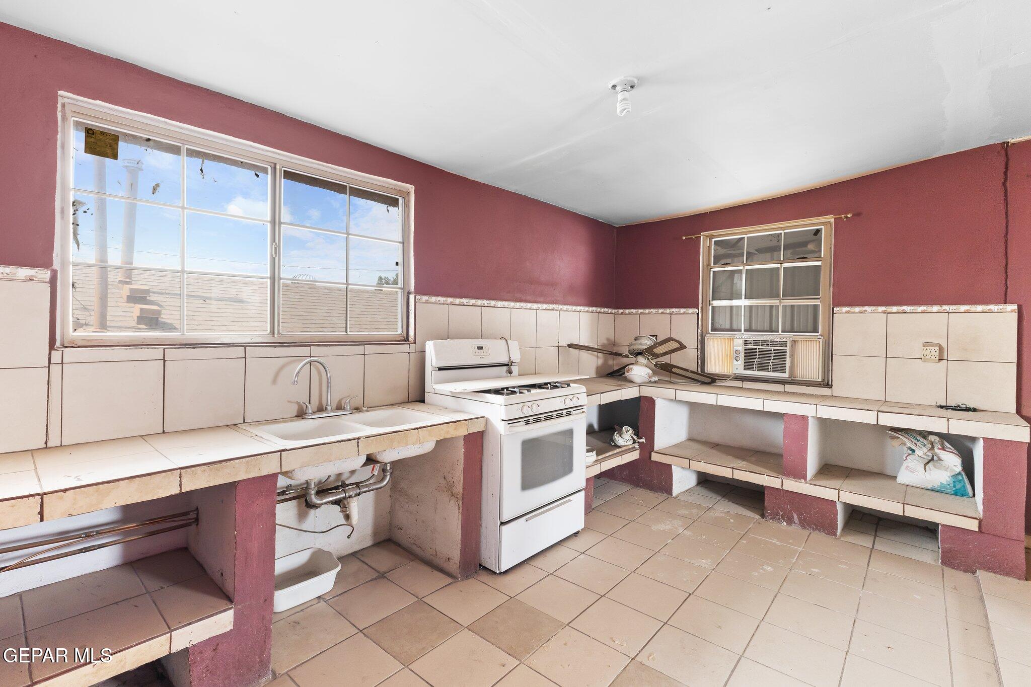 7080 2nd Avenue Canutillo, TX 79835 - Photo 34 of 38 a kitchen with a stove a sink and a refrigerator