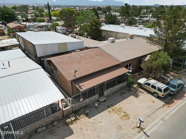 an aerial view of a house with swimming pool and mountain view