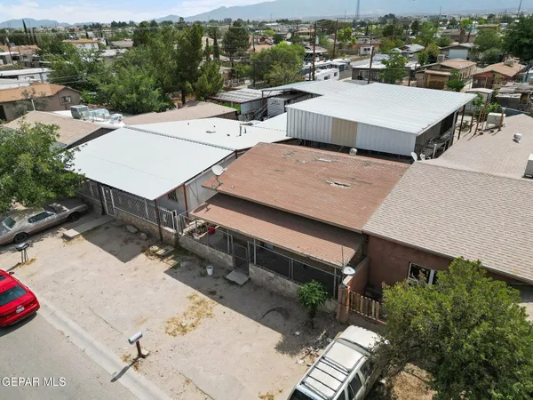 an aerial view of a house with swimming pool and mountain view