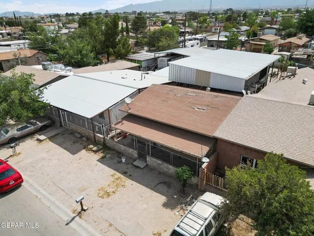 an aerial view of a house with swimming pool and mountain view