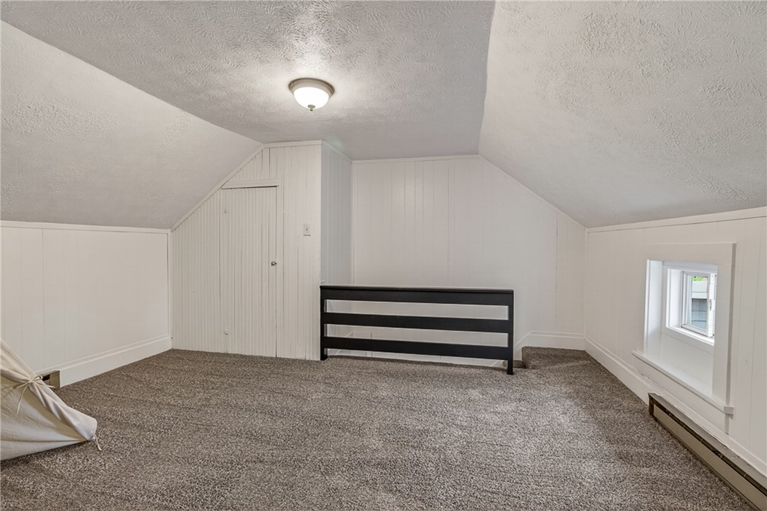 8700 Quaker Trace Road Camden, OH 45311 - Photo 20 of 34 This versatile attic space offers comfortable carpeting and sloped ceilings, perfect for various uses.