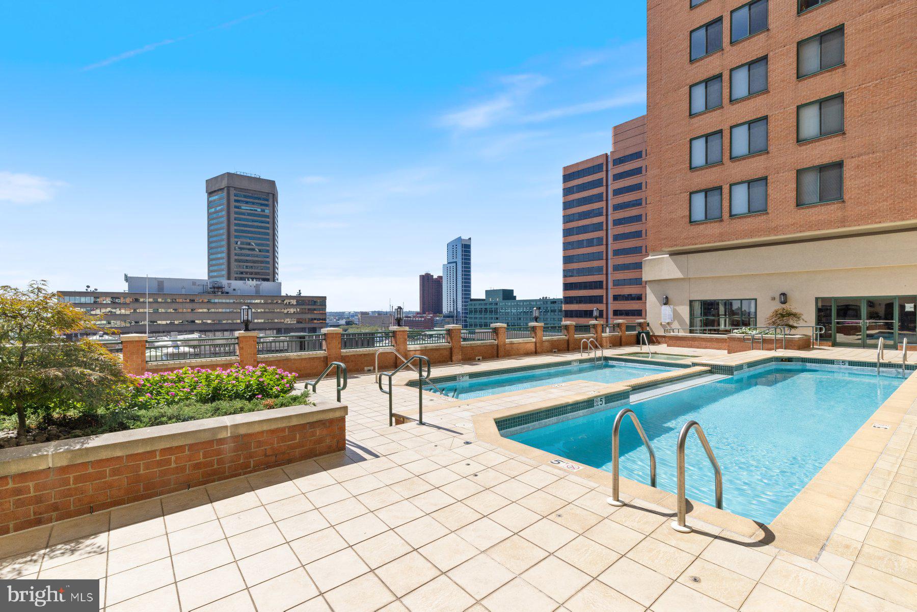 414 Water Street, Unit 2512 Baltimore, MD 21202 - Photo 36 of 40 a swimming pool with outdoor seating and city view