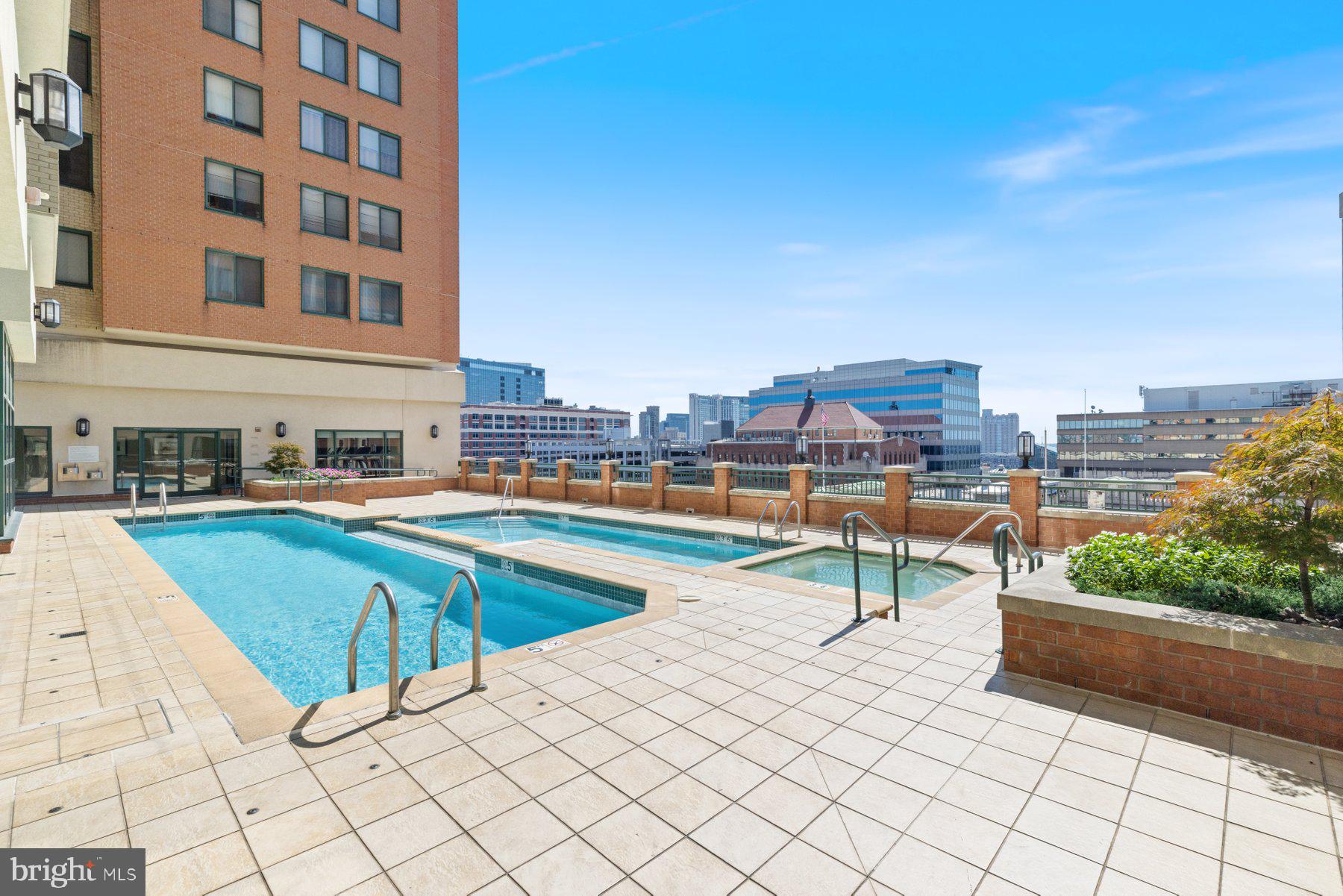 414 Water Street, Unit 2512 Baltimore, MD 21202 - Photo 37 of 40 a view of a swimming pool with a lounge chair