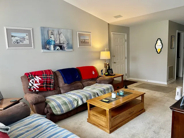 a living room with furniture and painting on the wall
