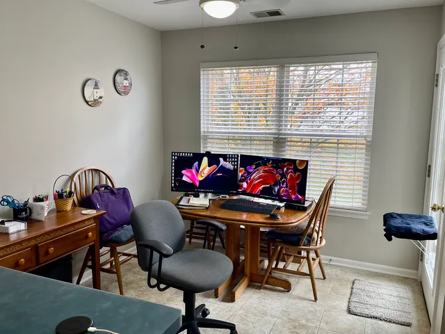 a view of a dining room with furniture and a window