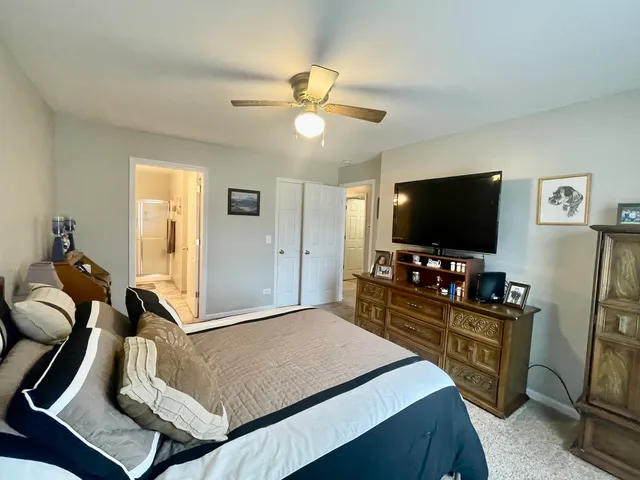 a bedroom with furniture and flat screen tv