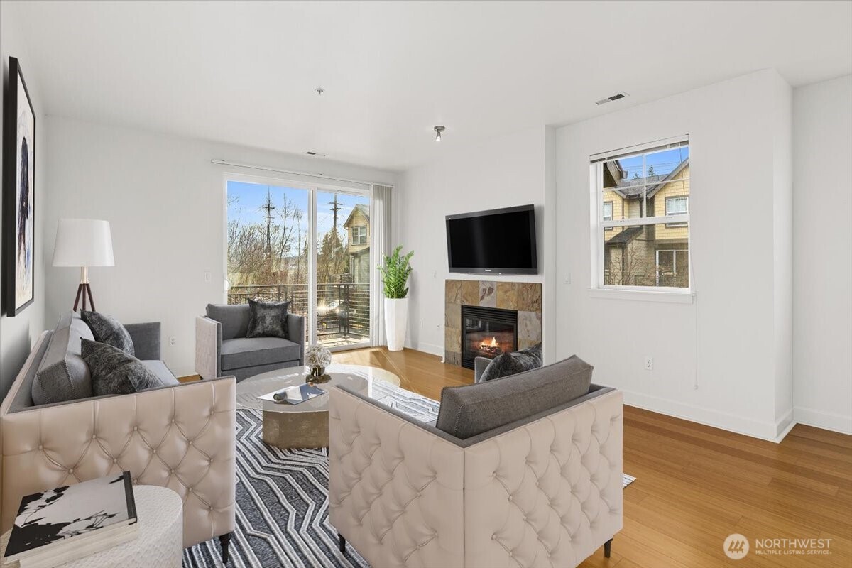 19102 20th Drive Southeast, Unit B206 Bothell, WA 98012 - Photo 12 of 39 a living room with furniture a fireplace and a flat screen tv