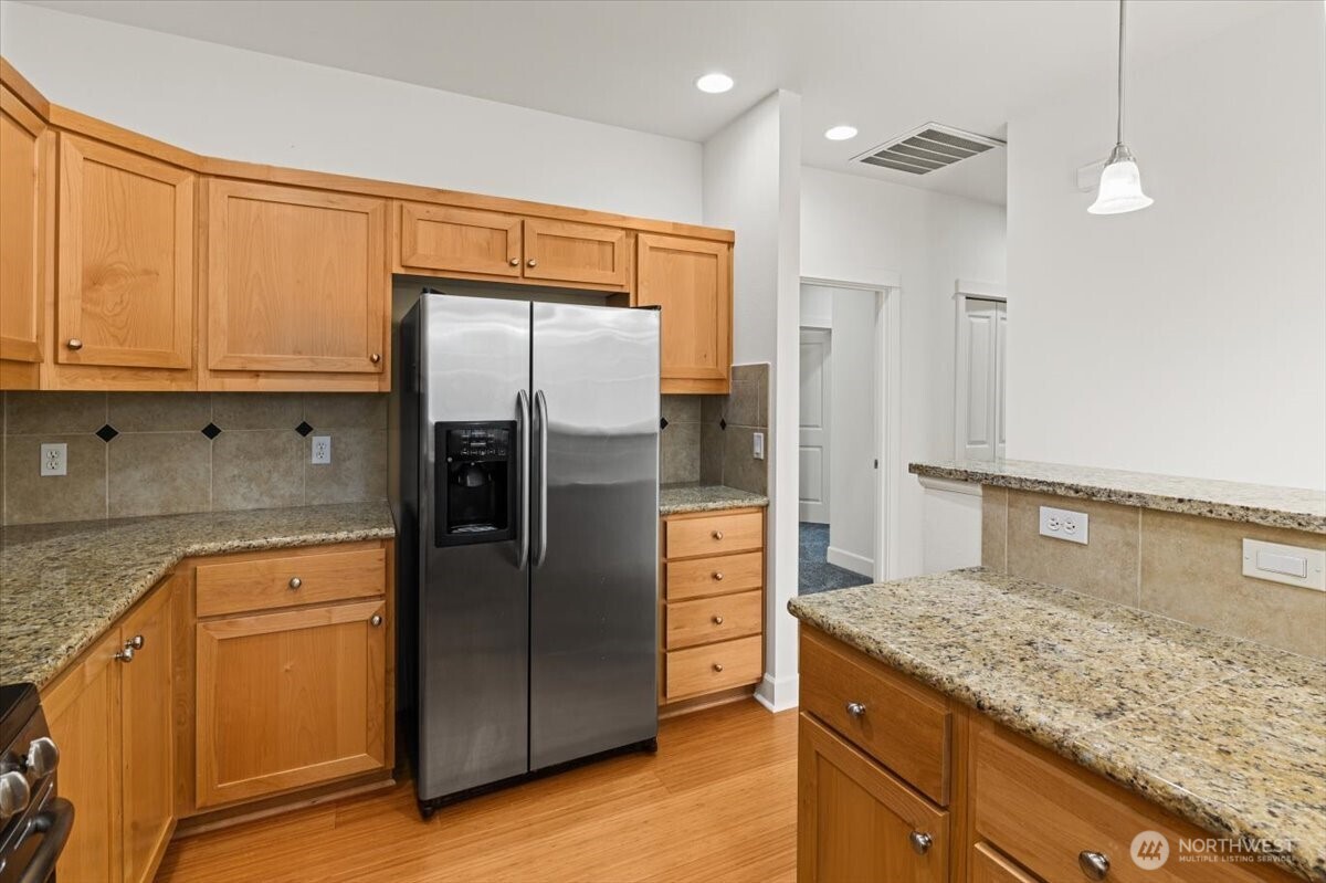 19102 20th Drive Southeast, Unit B206 Bothell, WA 98012 - Photo 22 of 39 a kitchen with stainless steel appliances granite countertop a refrigerator and a sink
