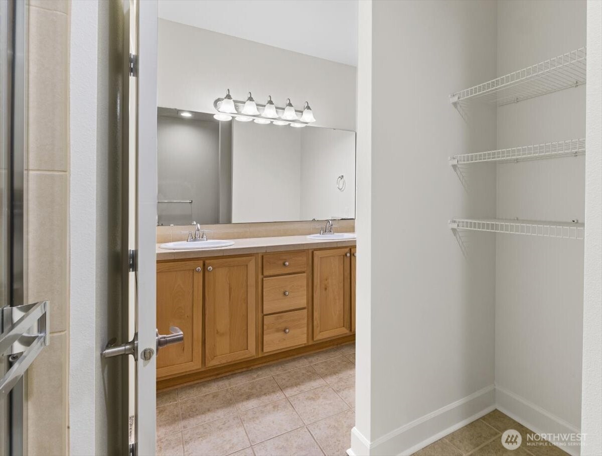 19102 20th Drive Southeast, Unit B206 Bothell, WA 98012 - Photo 28 of 39 a bathroom with a granite countertop sink and a mirror