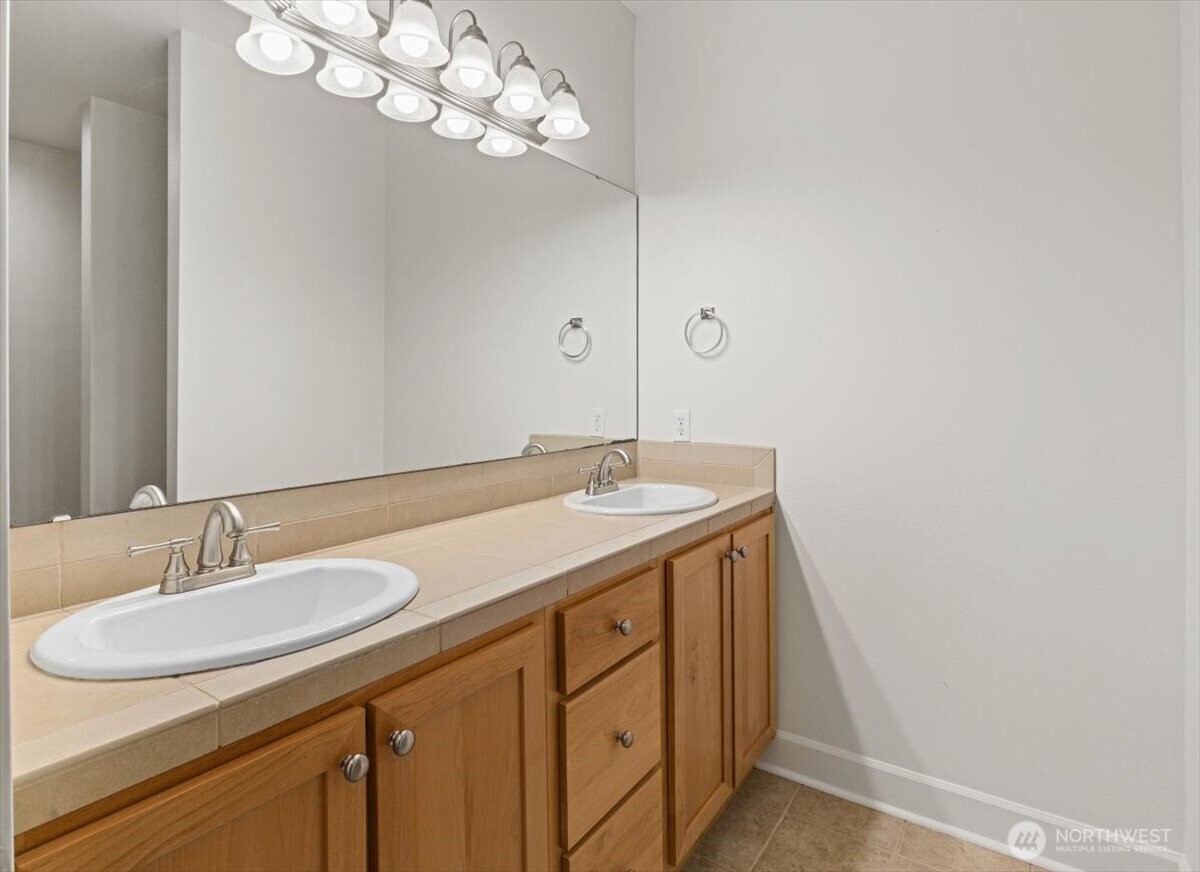 19102 20th Drive Southeast, Unit B206 Bothell, WA 98012 - Photo 29 of 39 a bathroom with a sink a light fixture and a mirror