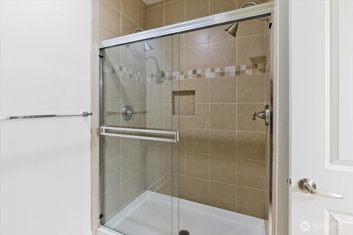 19102 20th Drive Southeast, Unit B206 Bothell, WA 98012 - Photo 30 of 39 a bathroom with a glass shower door