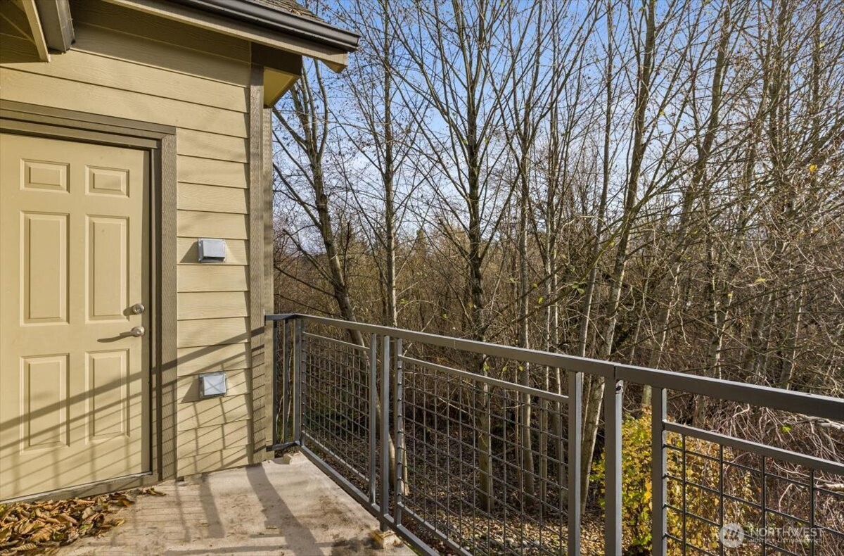 19102 20th Drive Southeast, Unit B206 Bothell, WA 98012 - Photo 35 of 39 a view of a balcony with wooden floor and fence