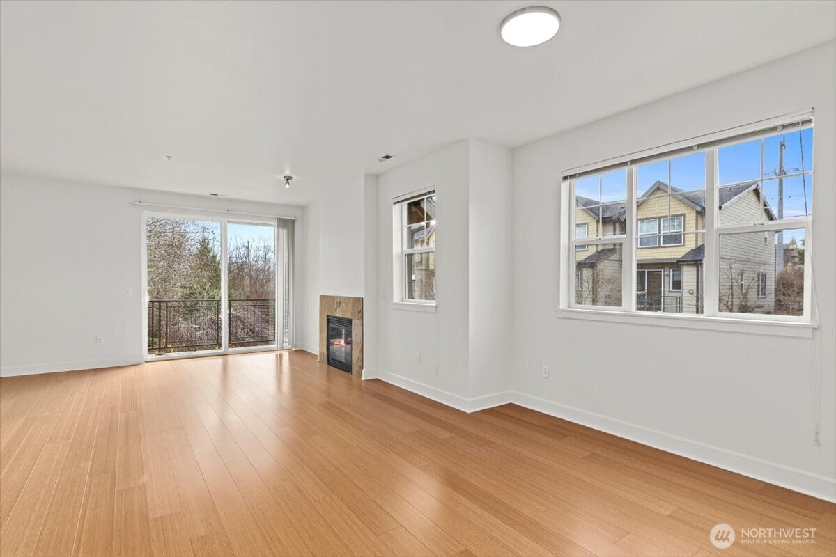 19102 20th Drive Southeast, Unit B206 Bothell, WA 98012 - Photo 6 of 39 a view of an empty room with wooden floor and a window