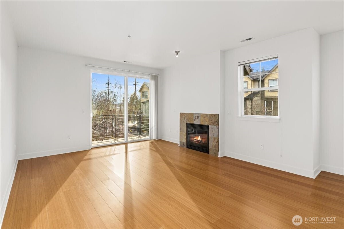 19102 20th Drive Southeast, Unit B206 Bothell, WA 98012 - Photo 10 of 39 a view of an empty room with wooden floor and a window