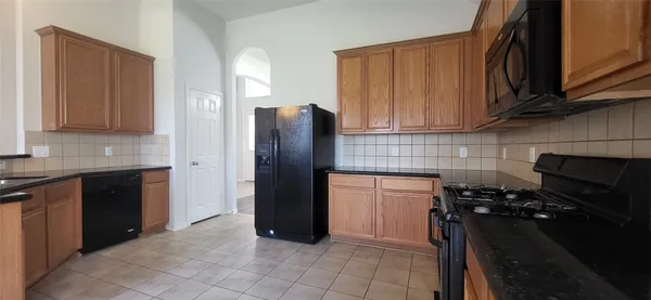 a kitchen with a refrigerator stove and cabinets
