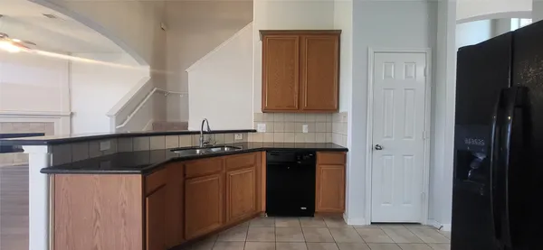 a kitchen with a sink and a refrigerator