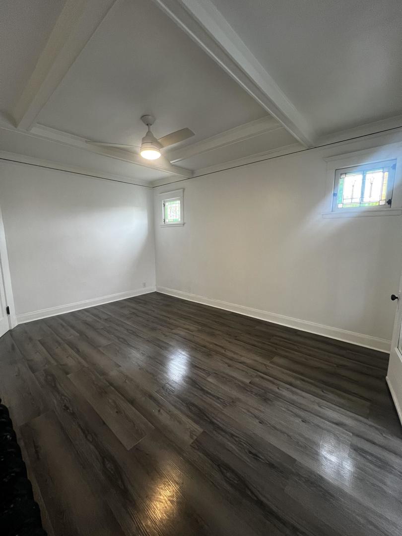 5461 West Haddon Avenue, Unit 2 Chicago, IL 60651 - Photo 12 of 21 an empty room with wooden floor and windows