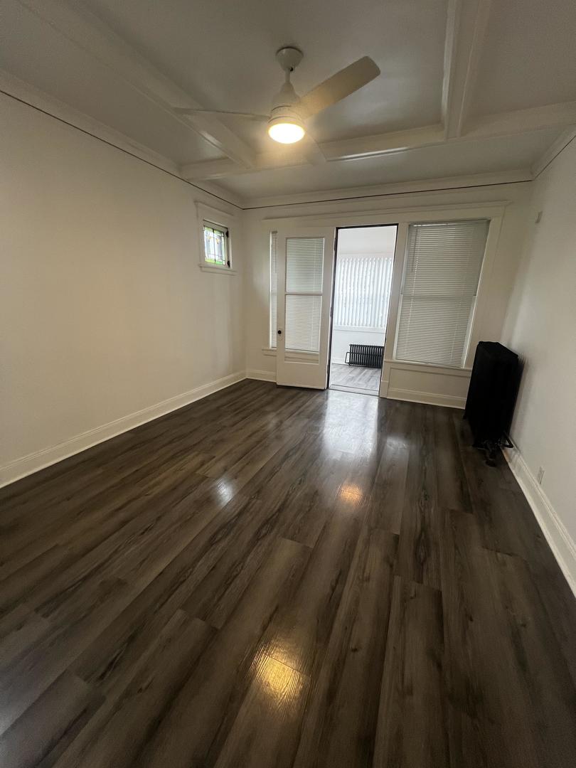 5461 West Haddon Avenue, Unit 2 Chicago, IL 60651 - Photo 13 of 21 an empty room with wooden floor and windows