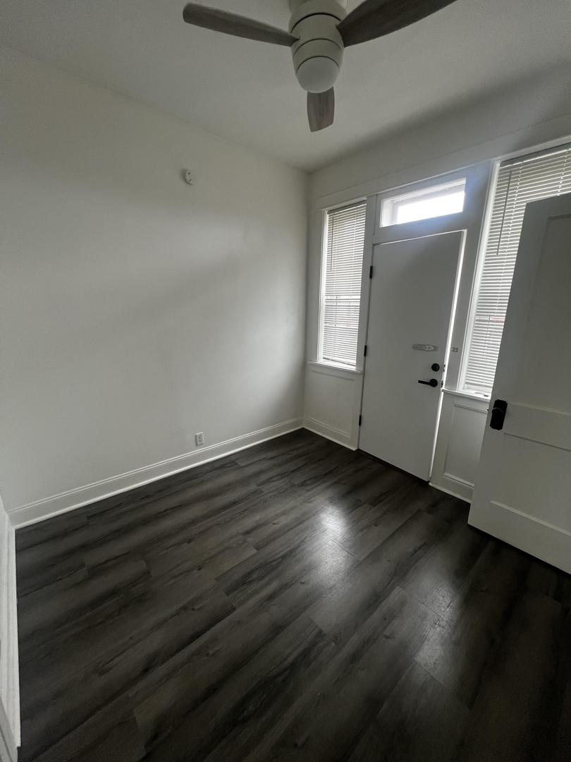 5461 West Haddon Avenue, Unit 2 Chicago, IL 60651 - Photo 17 of 21 an empty room with wooden floor and windows