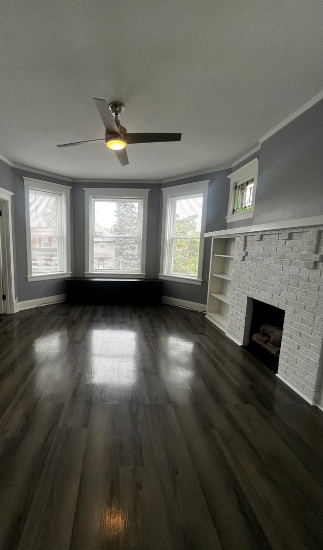 5461 West Haddon Avenue, Unit 2 Chicago, IL 60651 - Photo 5 of 21 an empty room with wooden floor and windows