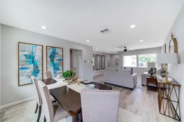 a living room with furniture and large windows