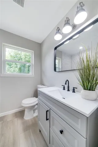 a bathroom with a sink toilet and mirror