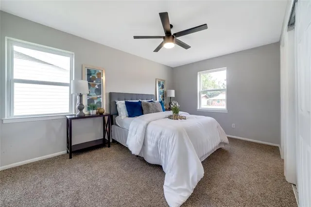 a bed room with a bed and a window