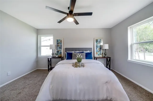 a spacious bedroom with a bed and a lamp