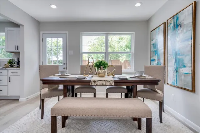 a view of a dining room with furniture and window