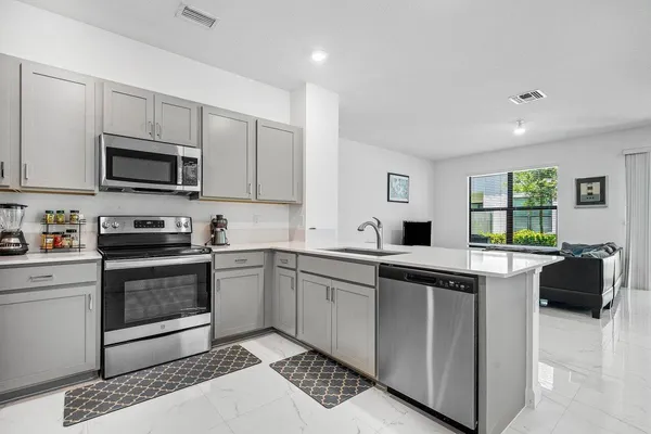a kitchen with a sink cabinets and stainless steel appliances