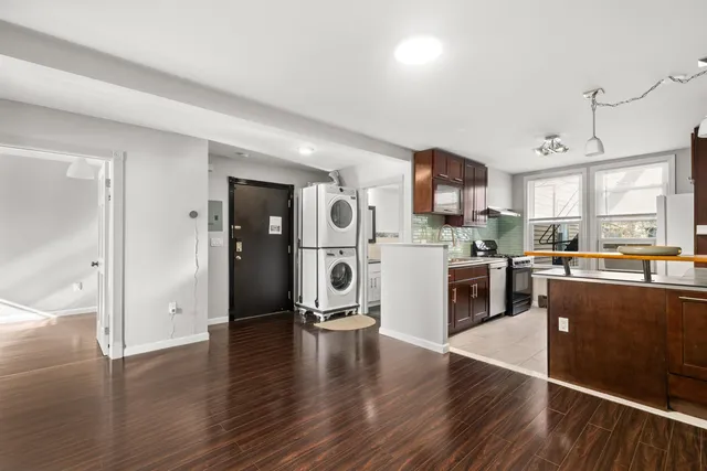 a kitchen with stainless steel appliances granite countertop a refrigerator and a stove top oven