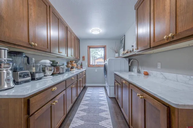 a kitchen with stainless steel appliances granite countertop lots of counter space cabinets and a sink