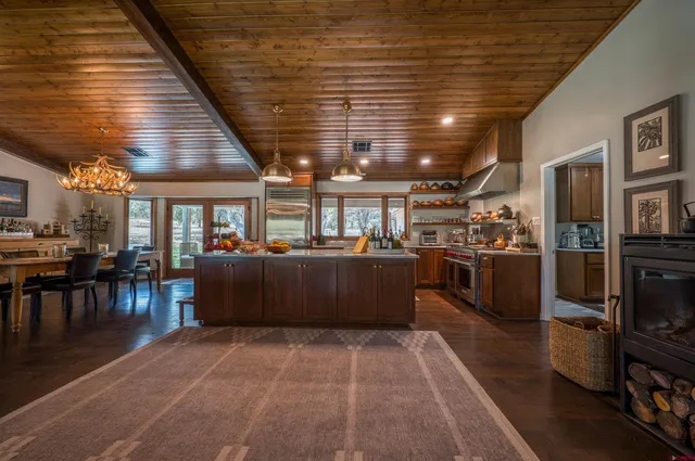 a living room with lots of furniture and kitchen