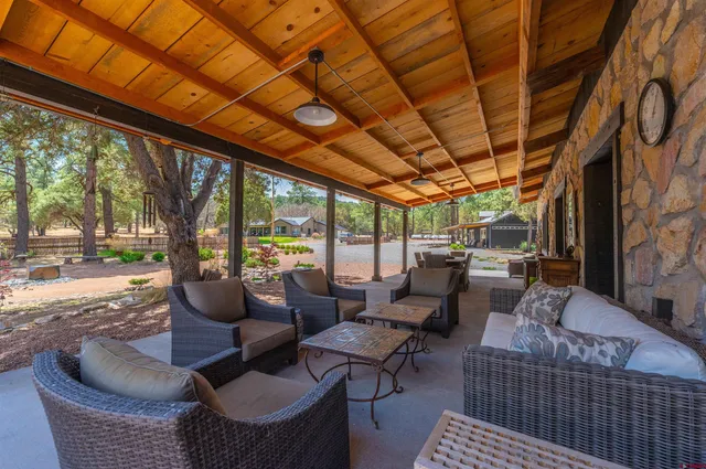 a outdoor living space with patio furniture and a floor to ceiling window