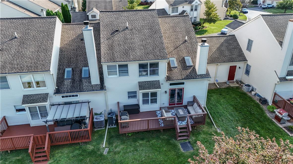 237 Ridings Circle Macungie, PA 18062 - Photo 9 of 70 An elevated perspective showcases the rear exterior featuring a spacious wooden deck and green lawn.
