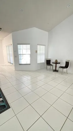 a living room with furniture and a ceiling fan