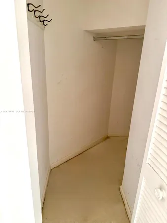 a view of a hallway with washer and dryer