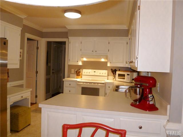 8505 Boot Court Raleigh, NC 27615 - Photo 7 of 25 a kitchen with a stove a refrigerator and cabinets