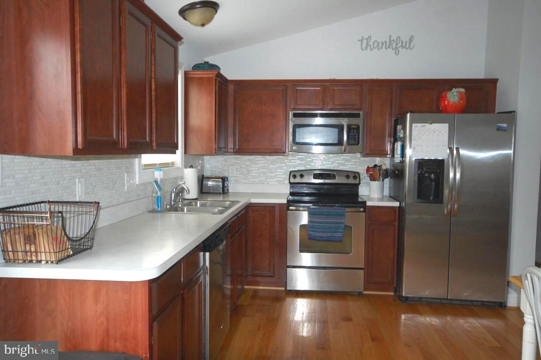 23 Job Inwood, WV 25428 - Photo 6 of 29 with stainless steel appliances & hardwood floors.