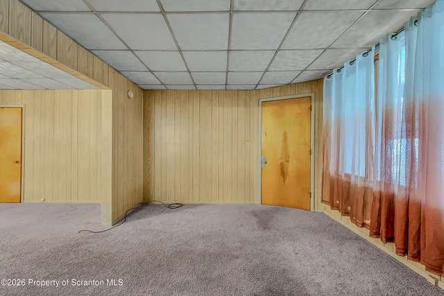 a view of empty room with chandelier