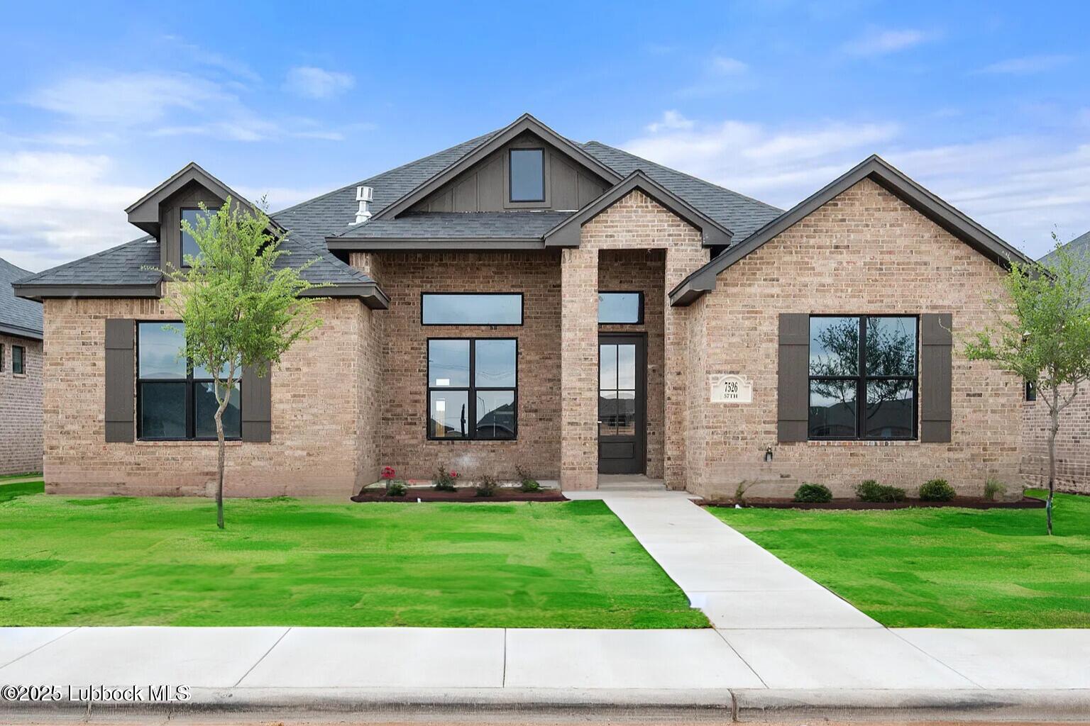 7526 57th Street Lubbock, TX 79407 - Photo 1 of 36 a front view of a house with a garden