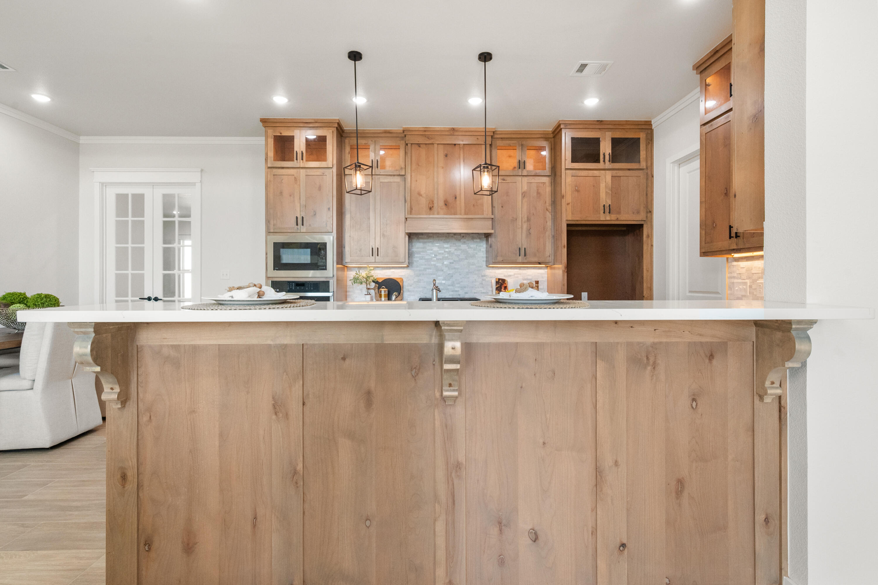 7526 57th Street Lubbock, TX 79407 - Photo 15 of 36 a large white kitchen with granite countertop a sink and cabinets