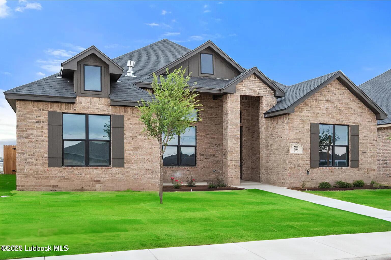 7526 57th Street Lubbock, TX 79407 - Photo 2 of 36 a front view of a house with a garden